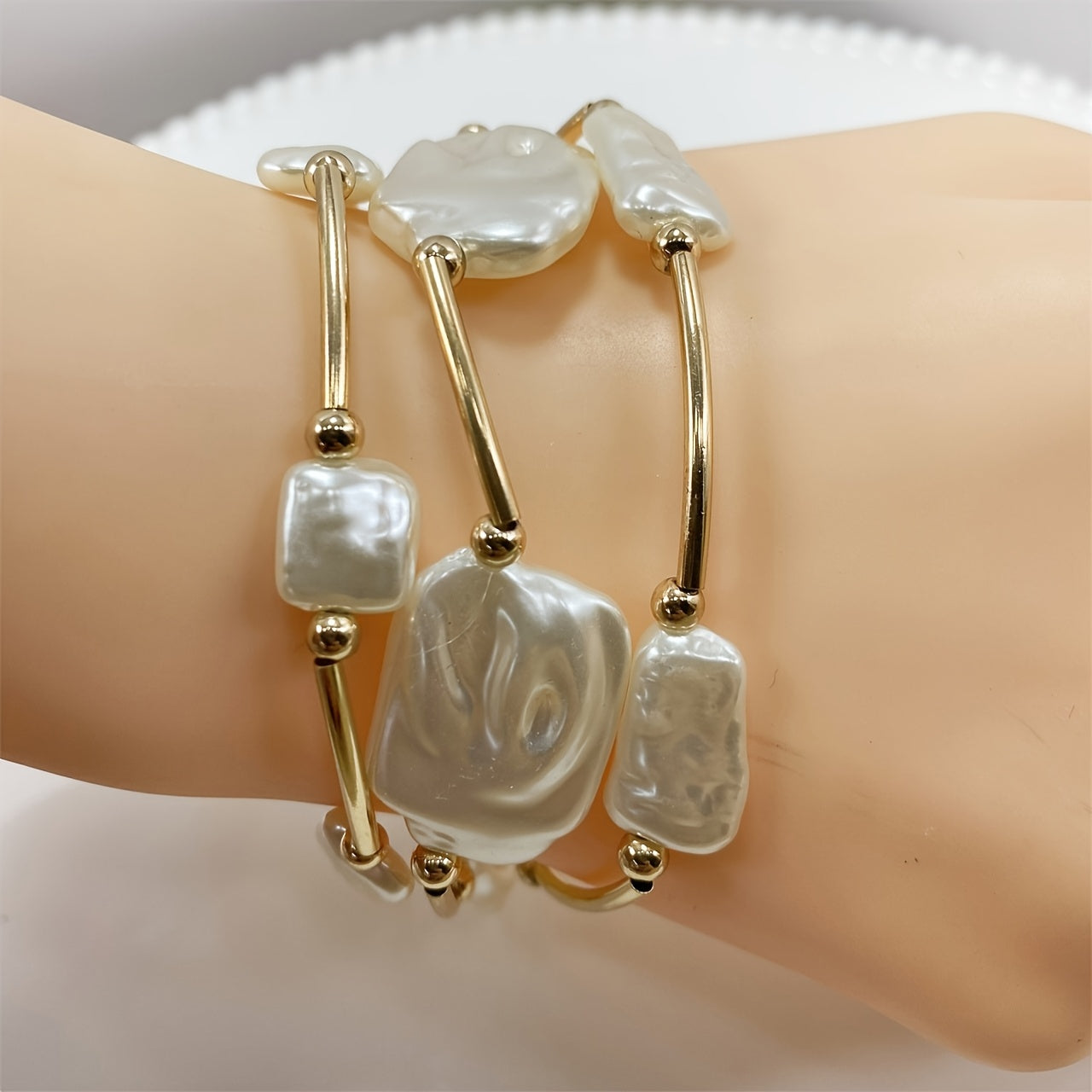 Close-up of the baroque pearls and gold bar links