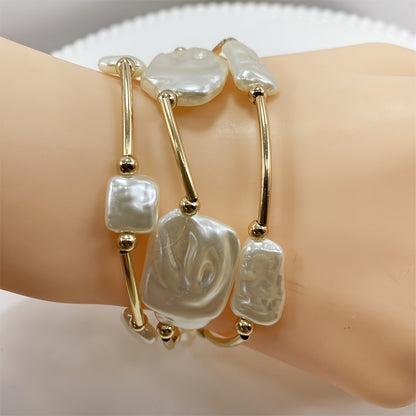 Close-up of the baroque pearls and gold bar links