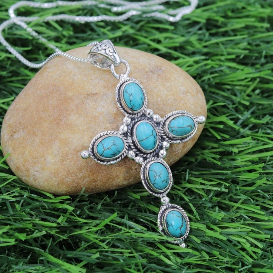 Bohemian Turquoise Cross Necklace on a stone