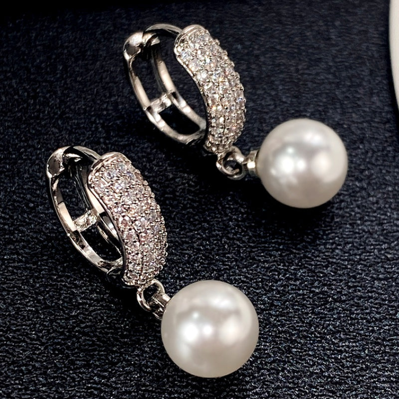 Refined Pearl Drop Hoop Earrings on a soft background