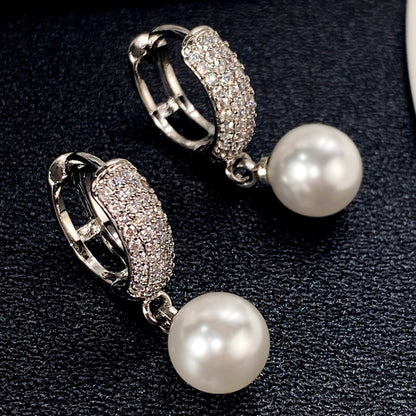 Refined Pearl Drop Hoop Earrings on a soft background