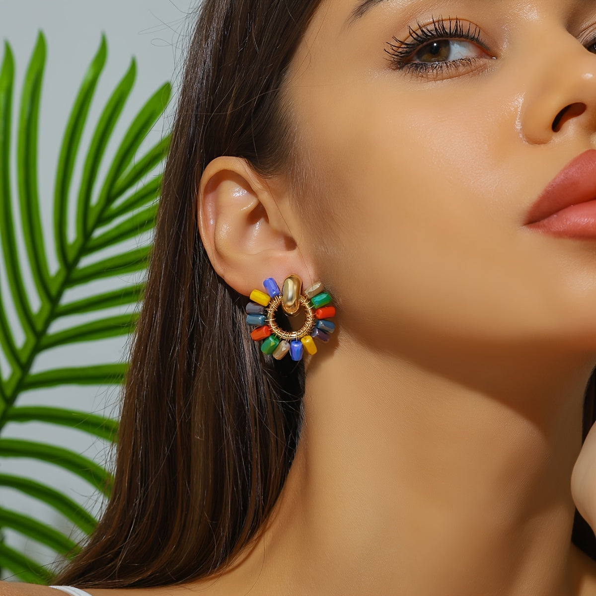 Beaded fan earrings worn on the ear