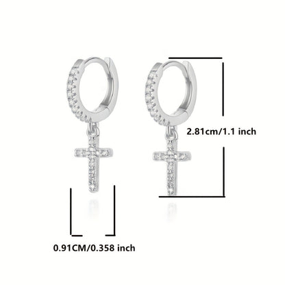 Close-up of the Polished Cross Huggie Earrings in silver