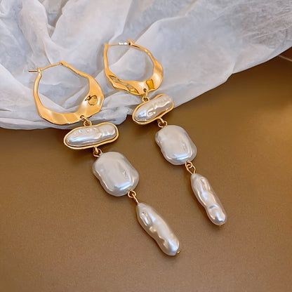 Close-up of the gold hoop and pearl detail