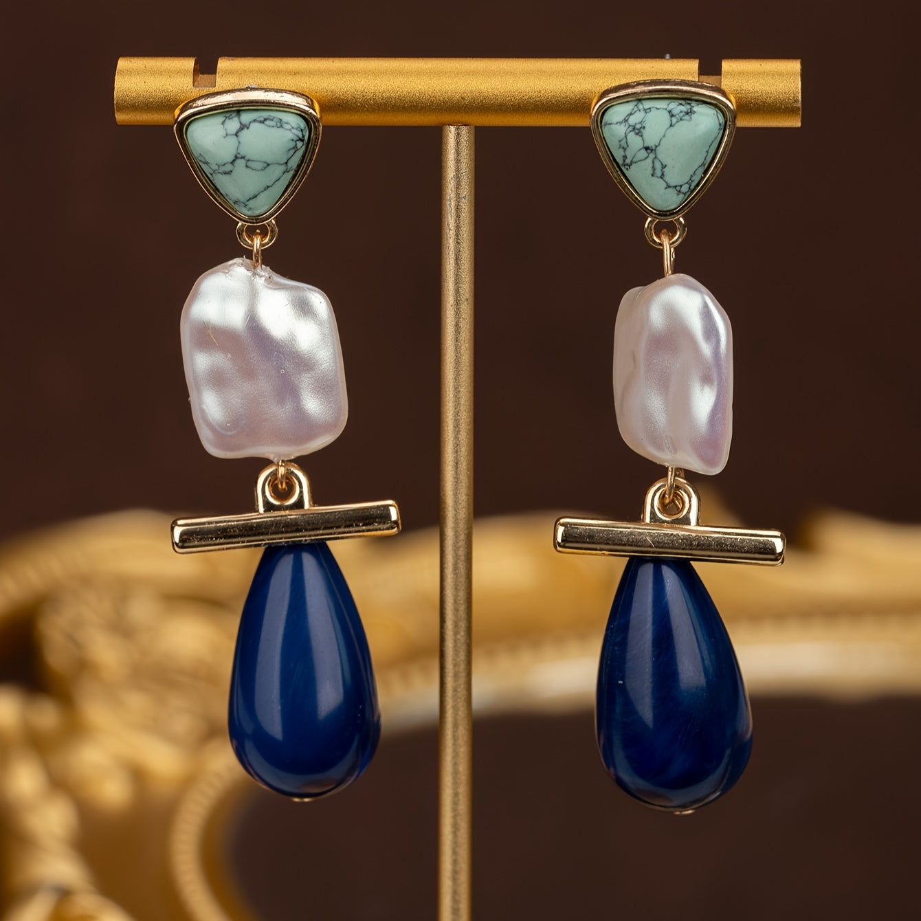 Both earrings shown on a display stand