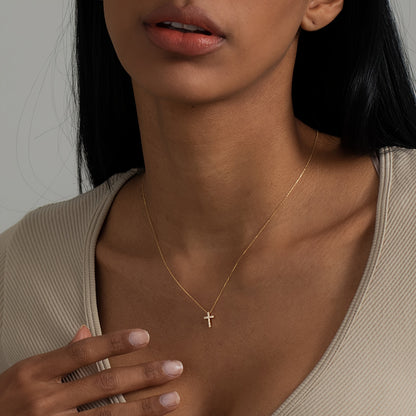 Close-up of the Refined Mini Cross Necklace worn on the neckline
