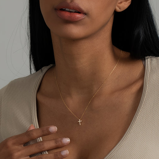 Close-up of the Refined Mini Cross Necklace worn on the neckline