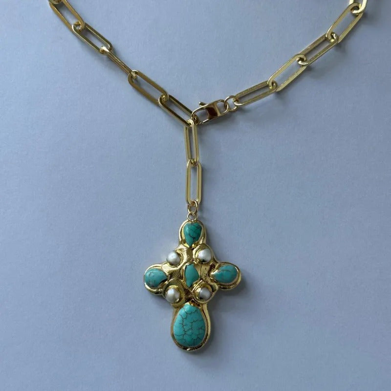 Detail of the turquoise cross and paperclip chain