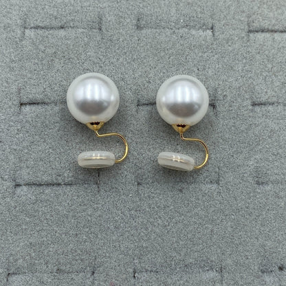 Vintage Round Pearl Clip Earrings on a light surface
