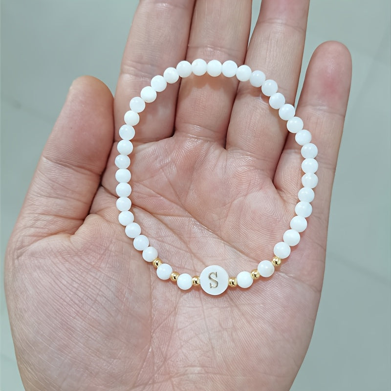 Elegant Initial Pearl Bracelet held in the hand