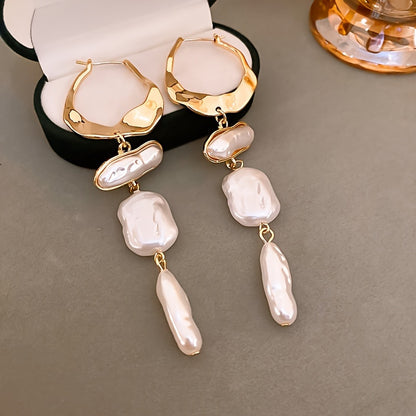 Elegant Baroque Pearl Hoop Earrings styled on a dark background