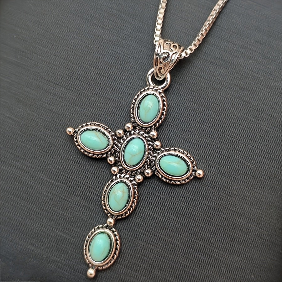 Bohemian Turquoise Cross Necklace pendant on dark background