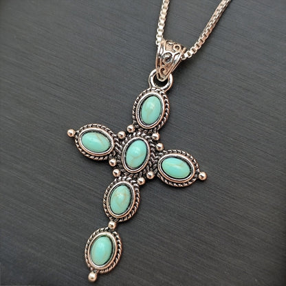 Bohemian Turquoise Cross Necklace pendant on dark background