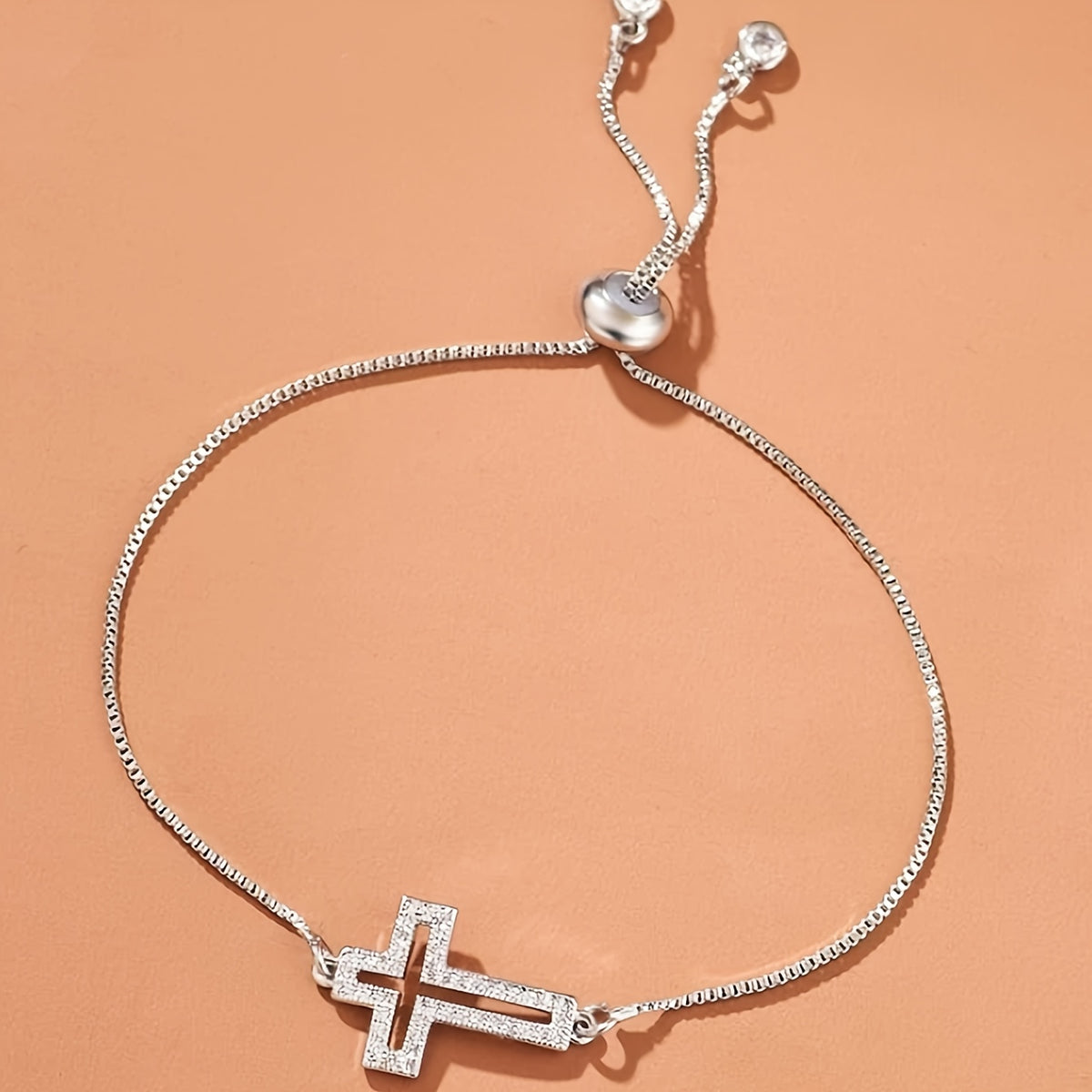 Classic Adjustable Cross Bracelet flat lay in gold