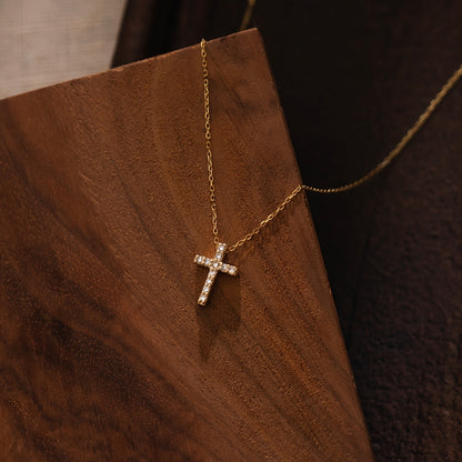 Refined Mini Cross Necklace styled on a wood board