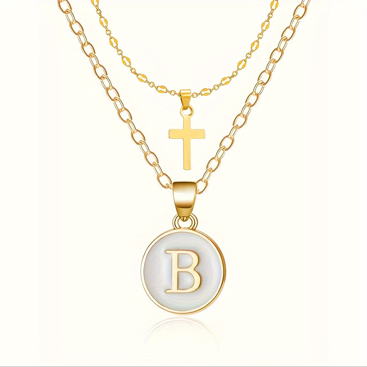 Close-up of the cross and initial pendants
