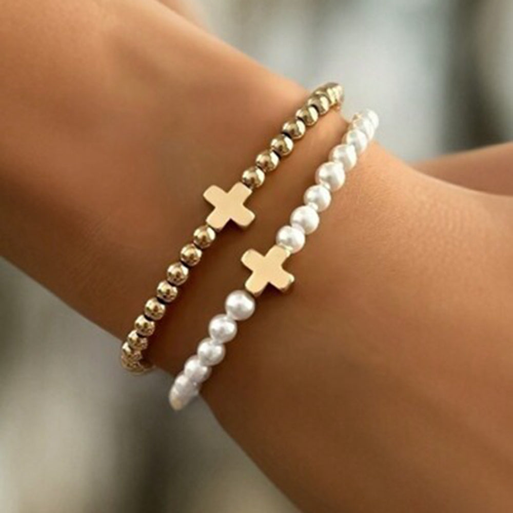 Delicate Pearl Cross Bracelet Set worn stacked on wrist