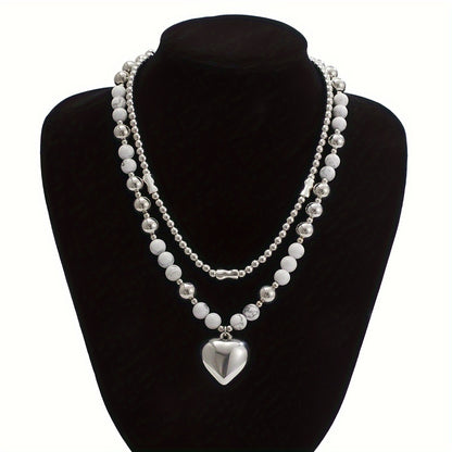 Both necklaces displayed on a stand