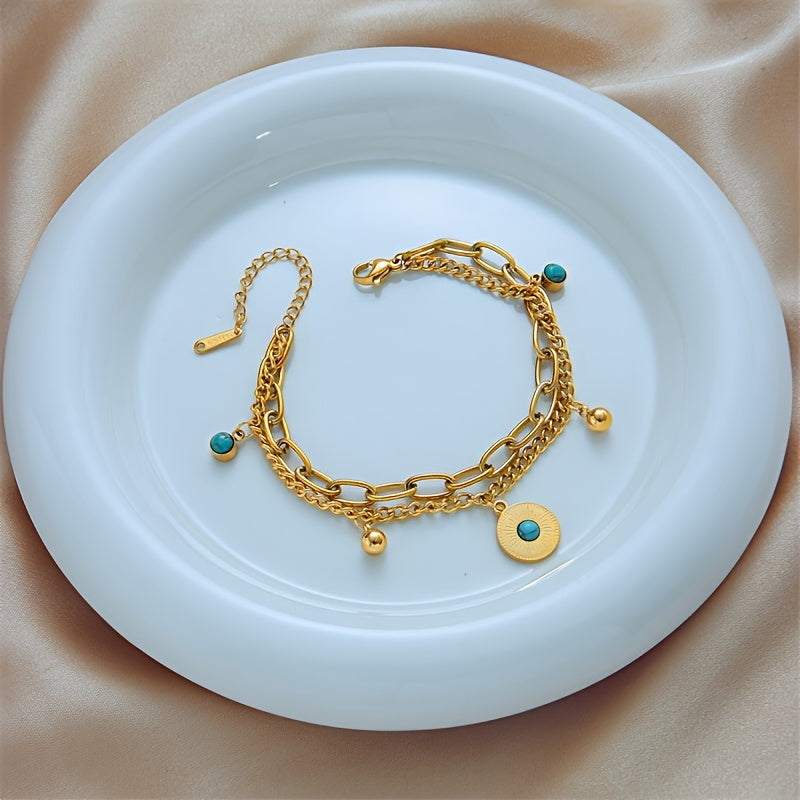 Elegant Gold Turquoise Layered Chain Bracelet styled on a dish