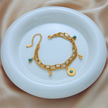 Elegant Gold Turquoise Layered Chain Bracelet styled on a dish
