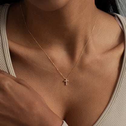 Refined Mini Cross Necklace worn layered over a sweater