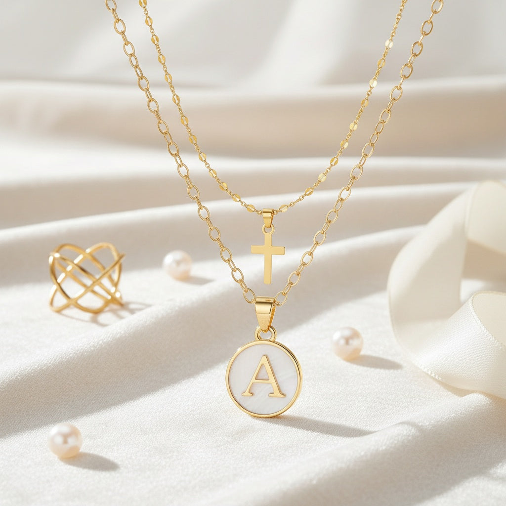 Timeless Cross & Initial Necklace Set styled flat lay