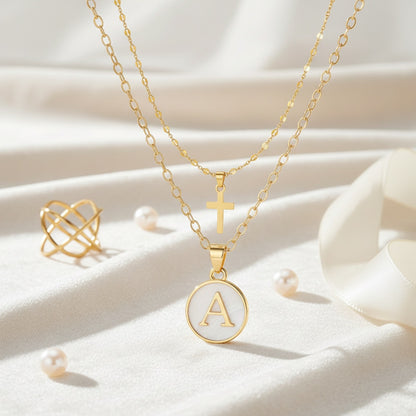 Timeless Cross & Initial Necklace Set styled flat lay
