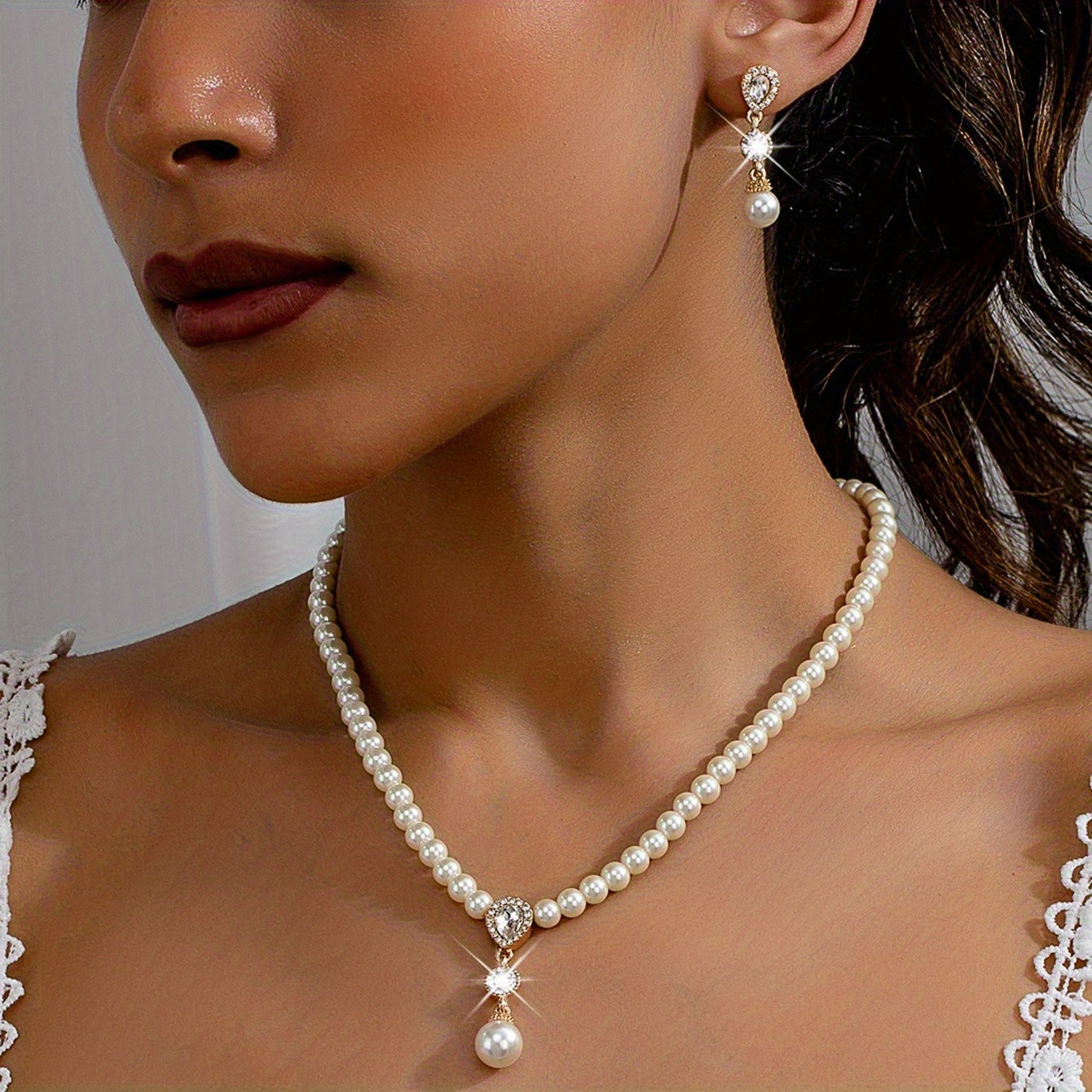 Necklace and earrings from the set worn together