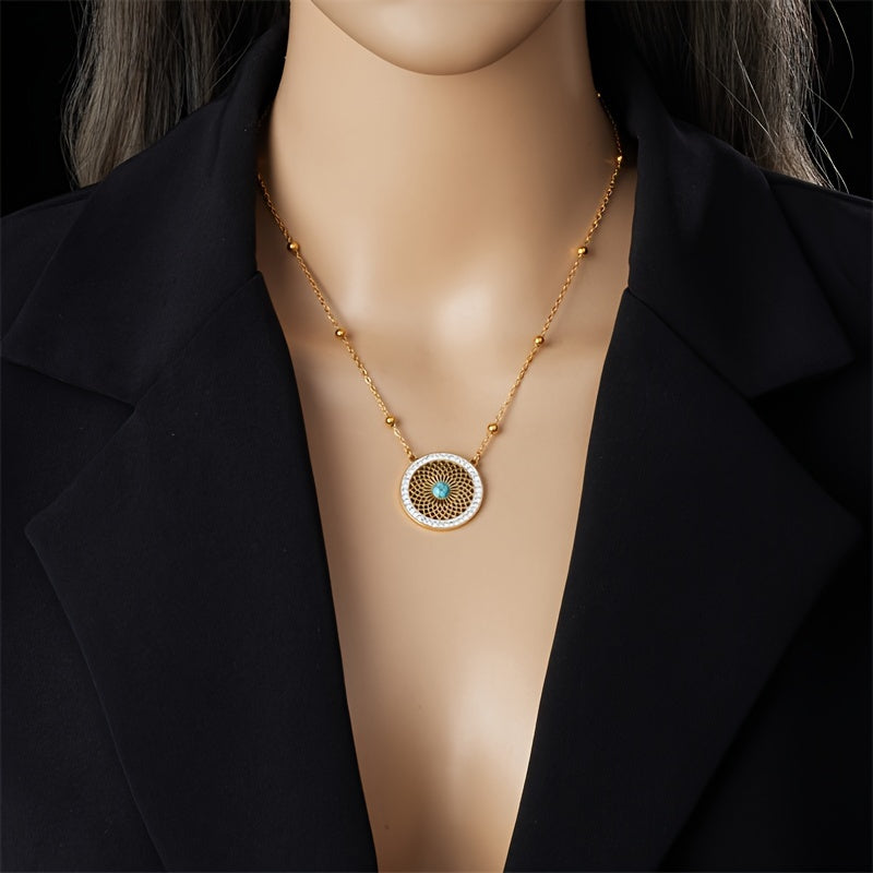 Turquoise medallion necklace worn with a dark blazer