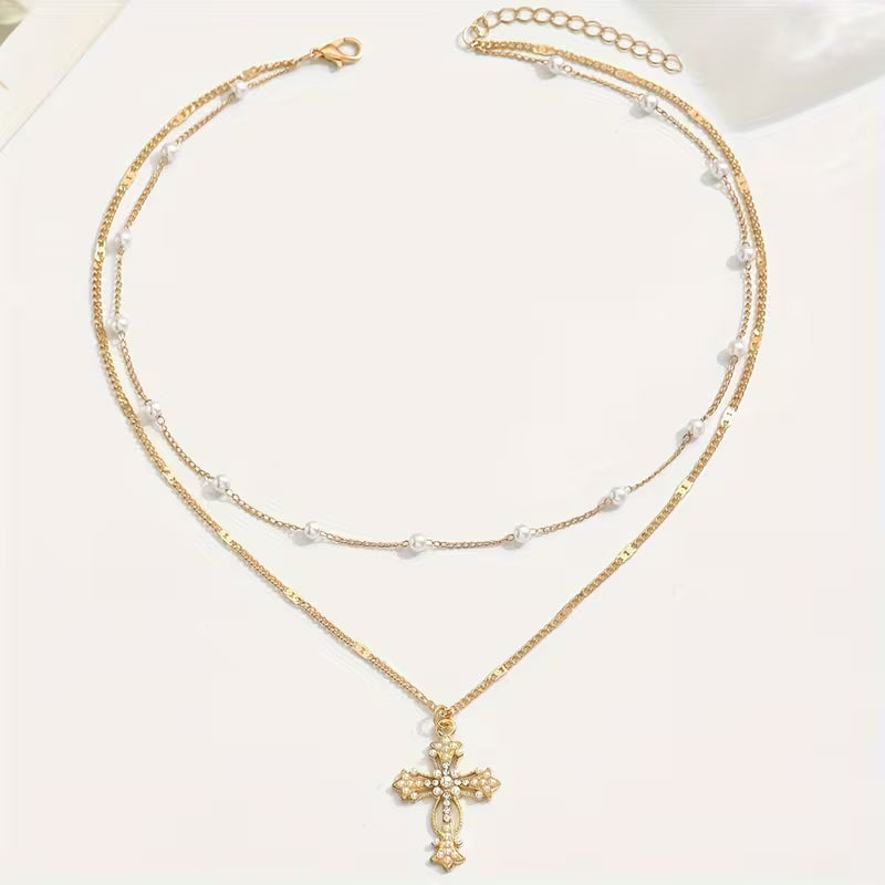 Close-up of the pearl and crystal cross pendant
